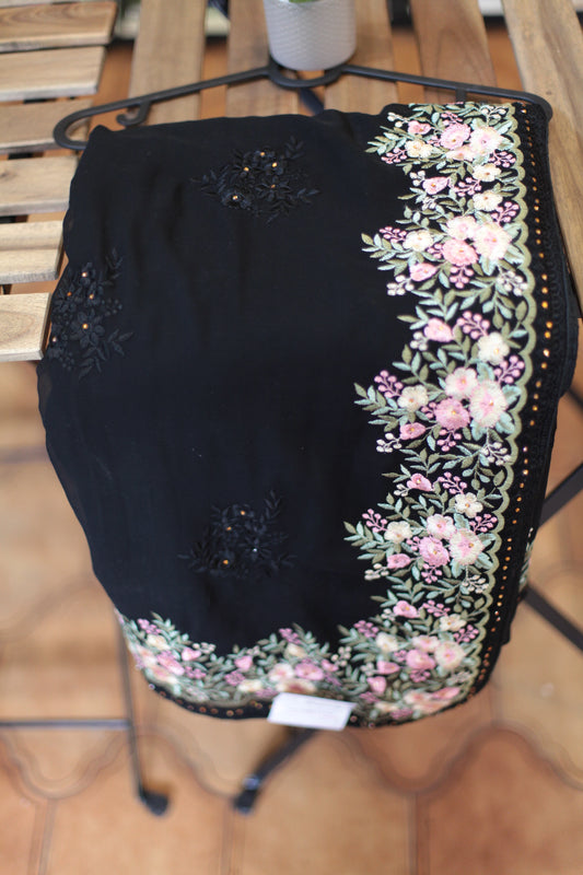 The saree is ornate, embroidered.